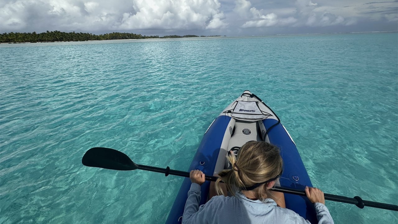 Katherine kayaking in crystal clear water in a lagoon